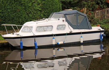Fototapeta na wymiar A Luxury River Cruiser Boat Moored on a Canal.