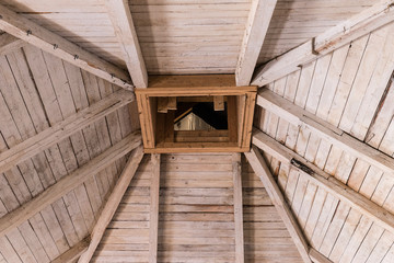 Old wooden roof, rafters and chimney.