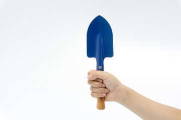 Hand of kid playing a shovel