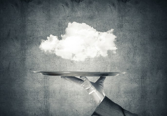 Hand of waitress presenting cloud on tray.