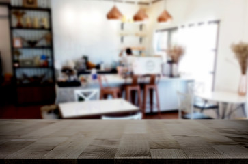 Selected focus empty brown wooden table and Coffee shop or restaurant blur background with bokeh image. for your photomontage or product display.