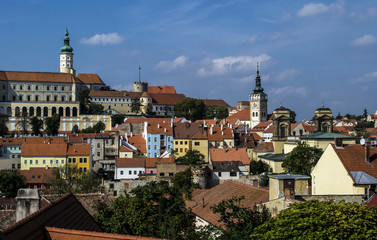 Fototapeta na wymiar multicolored houses of the historic city and two church towers and a chateau in the southern Moravia