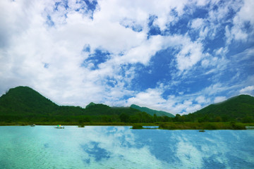 mountain hill blue sky heap cloud and reflection on lake