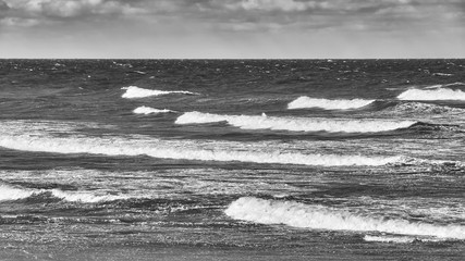 Black and white panoramic seascape on a stormy day.