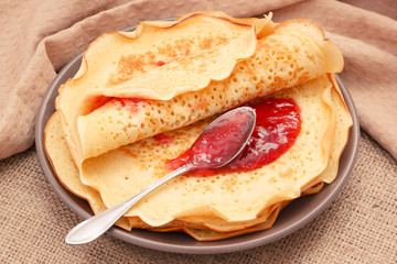 Fresh cooked homemade pancakes with sweet raspberry jam