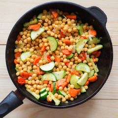 Stewed vegetables in a pan. Vegetarian dishes of chickpeas.
