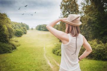 Beautiful woman looking on horizon in summer