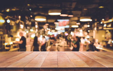 Wood table top (Bar) with blur night cafe background