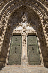 Obraz premium sculptures and ancient art reliefs on exterior of side door of the Primate Cathedral of Saint Mary, landmark and monument of the thirteenth century in Toledo city, Spain, Europe. Vertical shot 