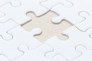 close up of White jigsaw puzzle with missed piece