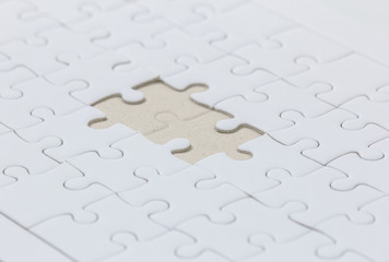 close up of White jigsaw puzzle with missed piece