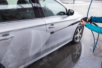 Car wash. High-pressure water and foam cleaning, aluminum wheels washing, winter maintenance