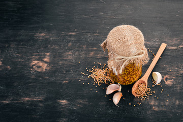 Grain Mustard. Spices On a dark wooden background. Top view. Copy space for your text.