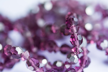Blurred abstract art closeup with selective focus of beautiful attractive shiny beads in a fashion...