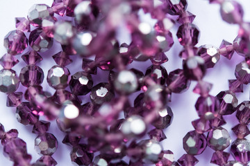 Blurred abstract art closeup with selective focus of beautiful attractive shiny beads in a fashion...