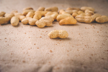  Peanuts in a pile on brown cloth for proper nutrition and healthy lifestyle