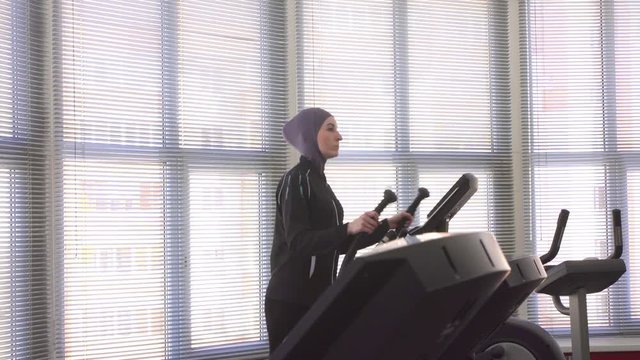 woman in hijab on step simulator