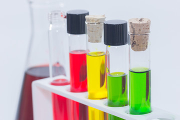 close up of colorful liquid in test tubes on rack