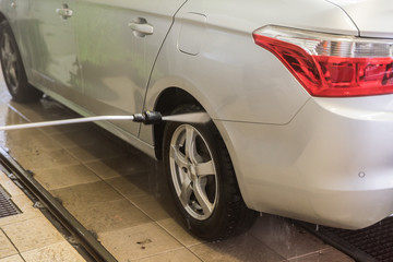 Car wash. High-pressure water and foam cleaning, aluminum wheels washing, winter maintenance