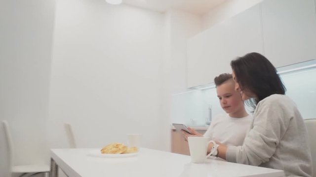 Mom Son Spend Time Holiday Eating Breakfast, mother and boy child on kichen, happy family