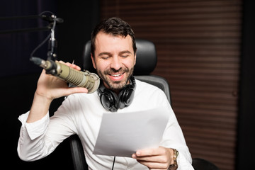 Smiling male radio host talking on his show