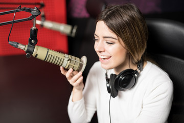 Radio presenter hosting show live in studio