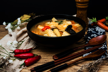 Bowls of Asian soup noodles and vegetables with Chopstick