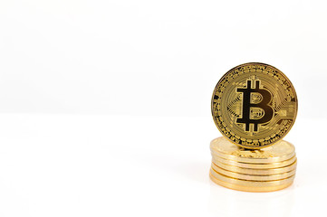Gold Bitcoins on white background. Selective focus..