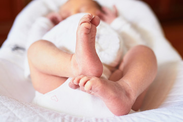 Tiny little feet of sleeping newborn baby