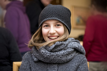 Portrait of a smiling little girl with woolen hat
