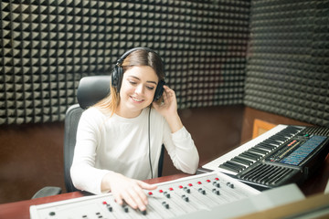 Female sound engineer working in recording studio