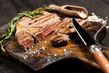Grilled steak on wooden cutting board