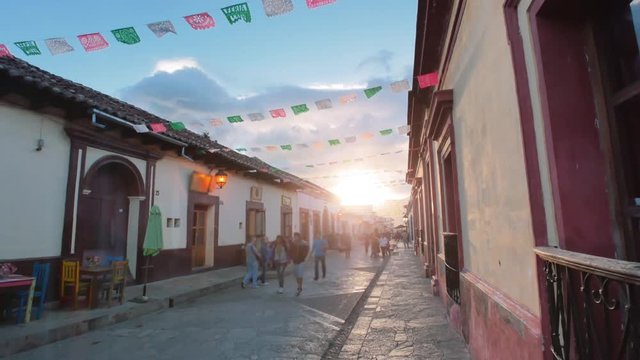 People walking at sunset on the main street of San Cristobal de las Casas, Chiapas. 4k