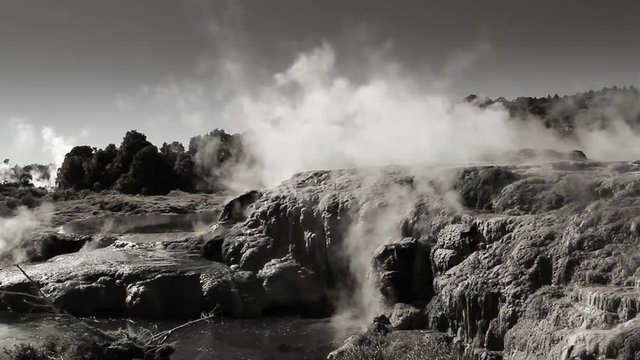 Geothermal area at Rotorua, New Zealand. Monochrome tinted footage. Hot springs, boiling pools, silica terraces, and steaming vents at Whakarewarewa Thermal Park - one of NZ's top tourist attractions.