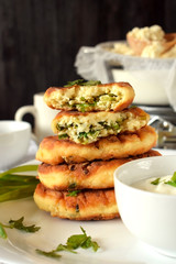 Golden cottage cheese pancakes syrniki and sour cream sauce on a white plate