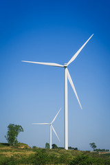 Wind turbine farm with blue sky and hill in Phetchabun, Thailand.