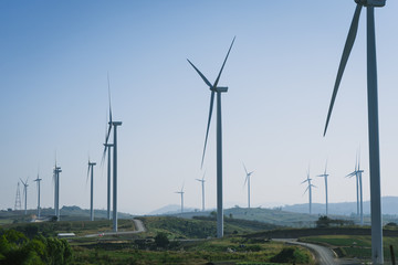 Wind turbine farm with blue sky and hill in Phetchabun, Thailand.