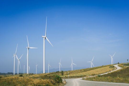 Wind turbine farm with blue sky and hill in Phetchabun, Thailand.