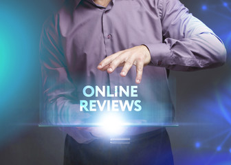 The concept of business, technology, the Internet and the network. A young entrepreneur working on a virtual screen of the future and sees the inscription: Online reviews