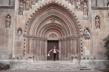 Traveller free woman in front of The Chapel of Jak in Vajdahunyad Castle in the City Park in Budapest, Hungary. © Victoria Andreas