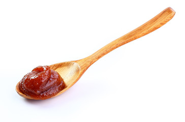jam in wooden spoon isolated white background