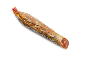 Piece of Spanish chorizo sausage (Chorizo iberico) isolated on white background. Iberian pork meat.