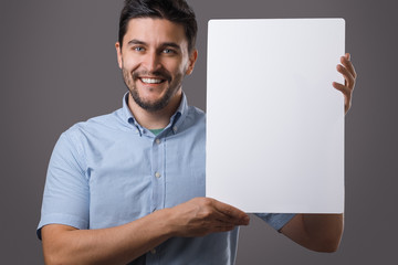 Youn man holds board