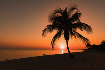 Fototapeta na wymiar Cuba, Playa Ancon beach. Colorful sunset at Playa Ancon Near Trinidad in Cuba