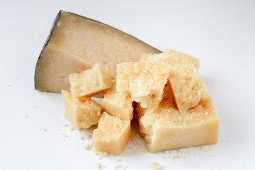 Pieces of Italian Parmesan on a white background