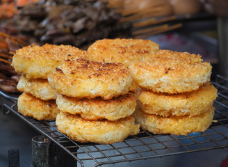 Roast sticky rice lumps (Kgawhie or Khao jee) sold on street market, Bangkok, Thailand , Thai traditional recipe 