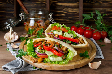 Pita bread sandwiches with meat, beans and vegetables