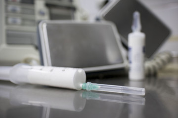 cardiac defibrillator and the syringe of propofol on the medical table