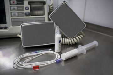 cardiac defibrillator and the syringe of propofol on the medical table