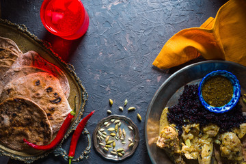 Bread of chapati, chicken curry and black rice. Indian food